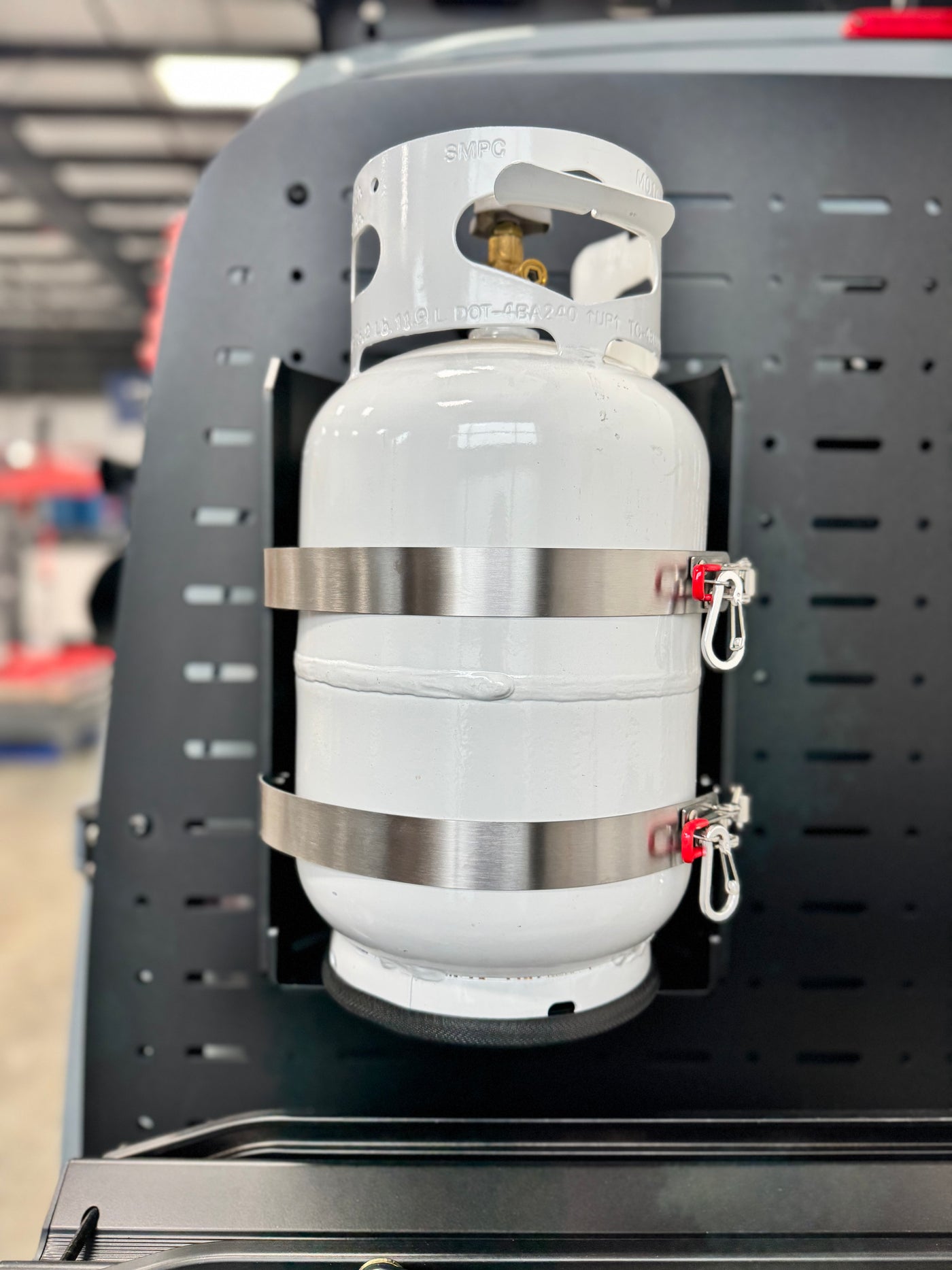 Aluminum and stainless propane tank carrier Shuksan PS-10 Propane Shuttle for 10lb tank mounted in a garage environment