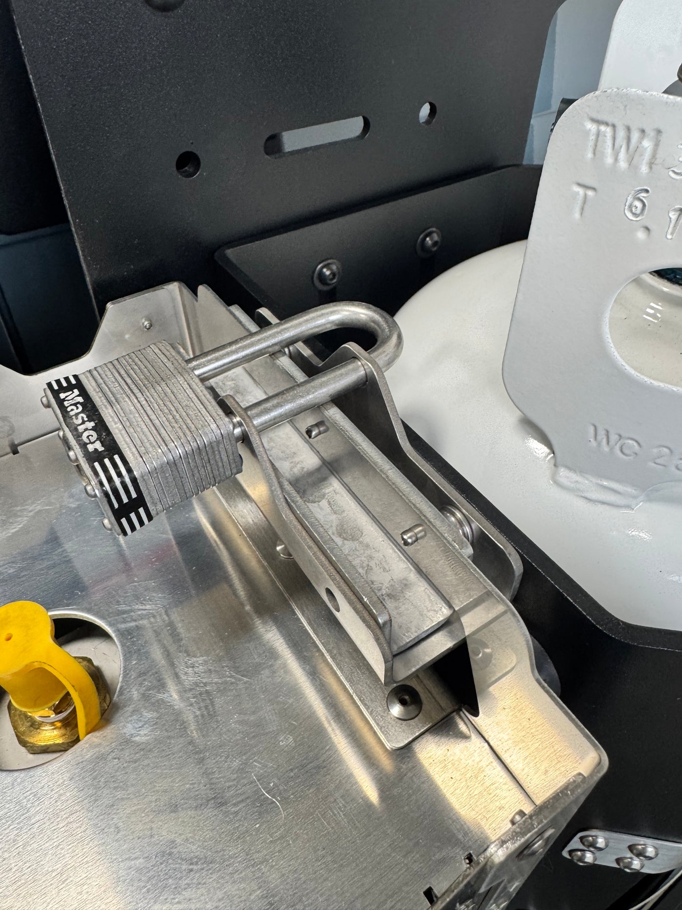 Stainless lock securing Howl R1 to Shuksan PS-10-HR1 combination propane tank mount